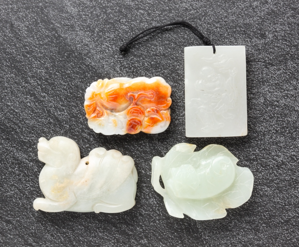 Appraisal: FOUR CHINESE JADE CARVINGS Twentieth century Three pendants including winged