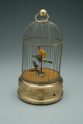 Appraisal: Two mechanical singing birds in brass and ironwork cage in