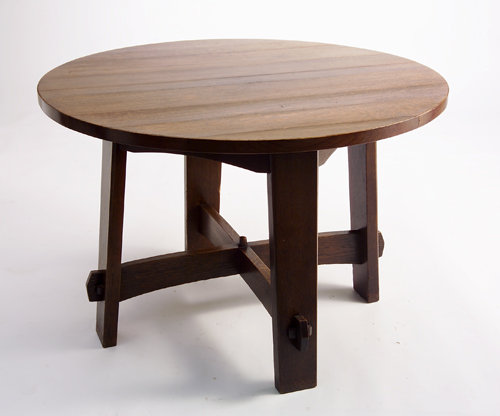 Appraisal: GUSTAV STICKLEY Breakfast table with shaped apron faceted finial stretchers