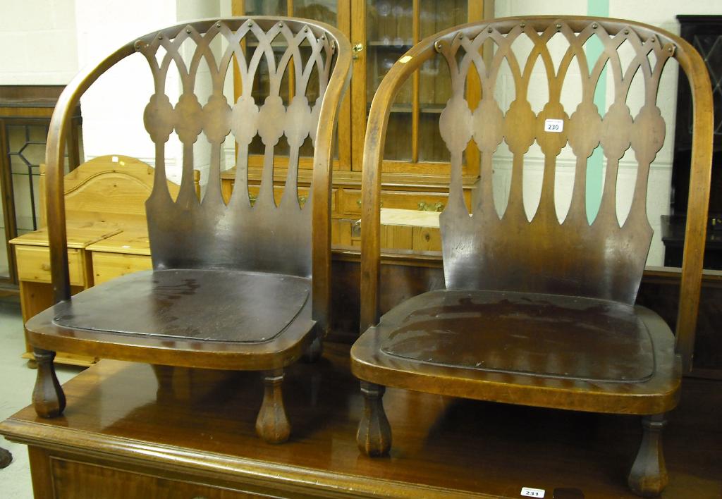 Appraisal: Pair of 's Gothic Revival low fireside chairs