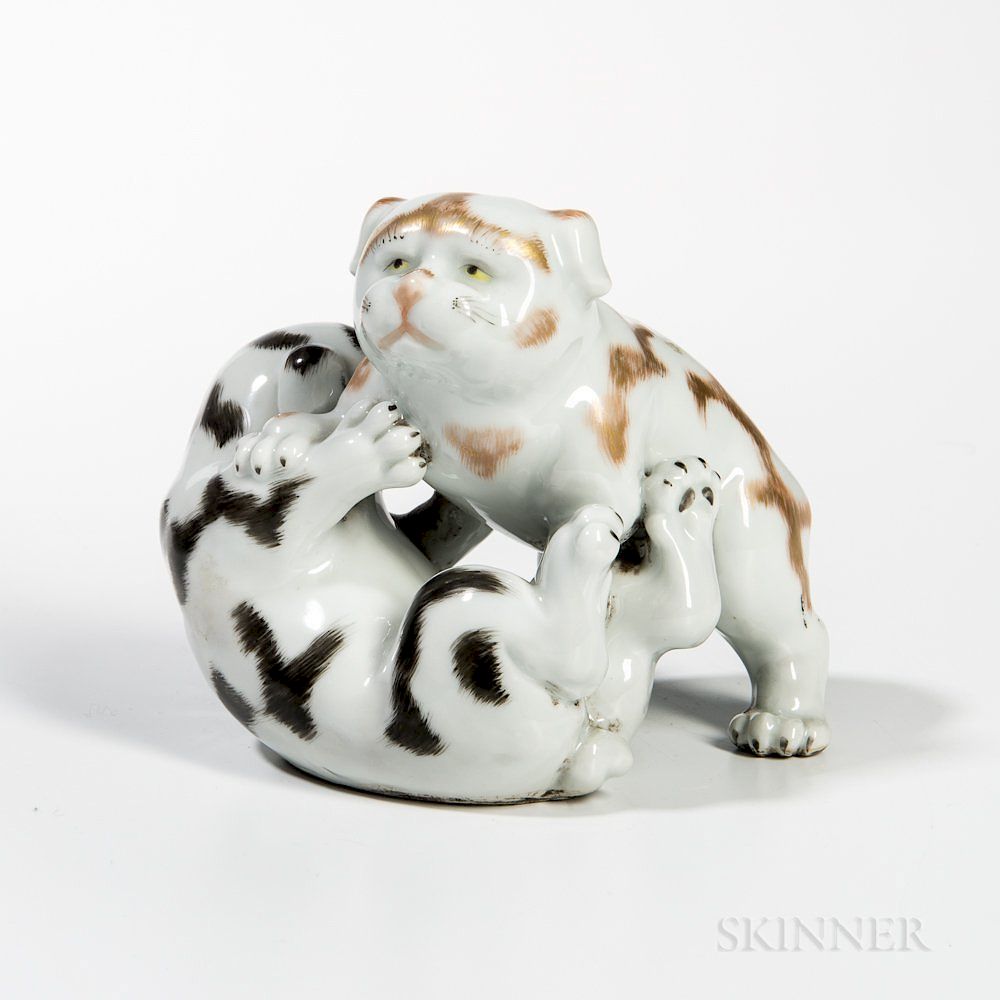 Appraisal: White-glazed Porcelain Figurine of Two Puppies Wrestling White-glazed Porcelain Figurine