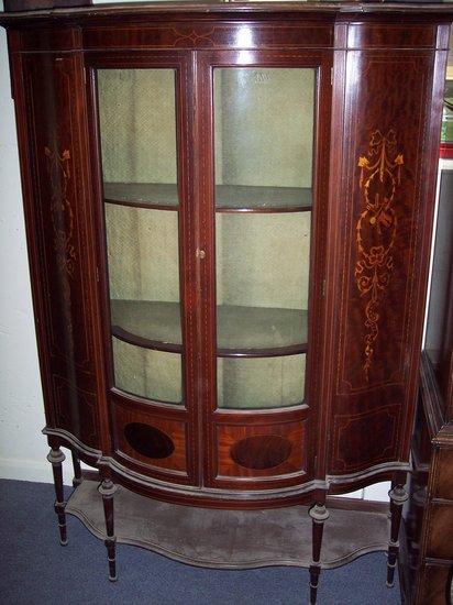 Appraisal: An Edwardian mahogany serpentine front china cabinet with ebony and