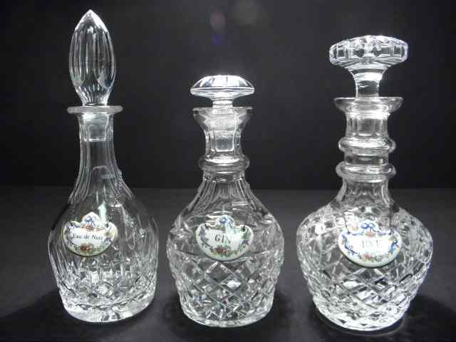 Appraisal: Three cut crystal decanters with porcelain Crown Staffordshire and Coalport