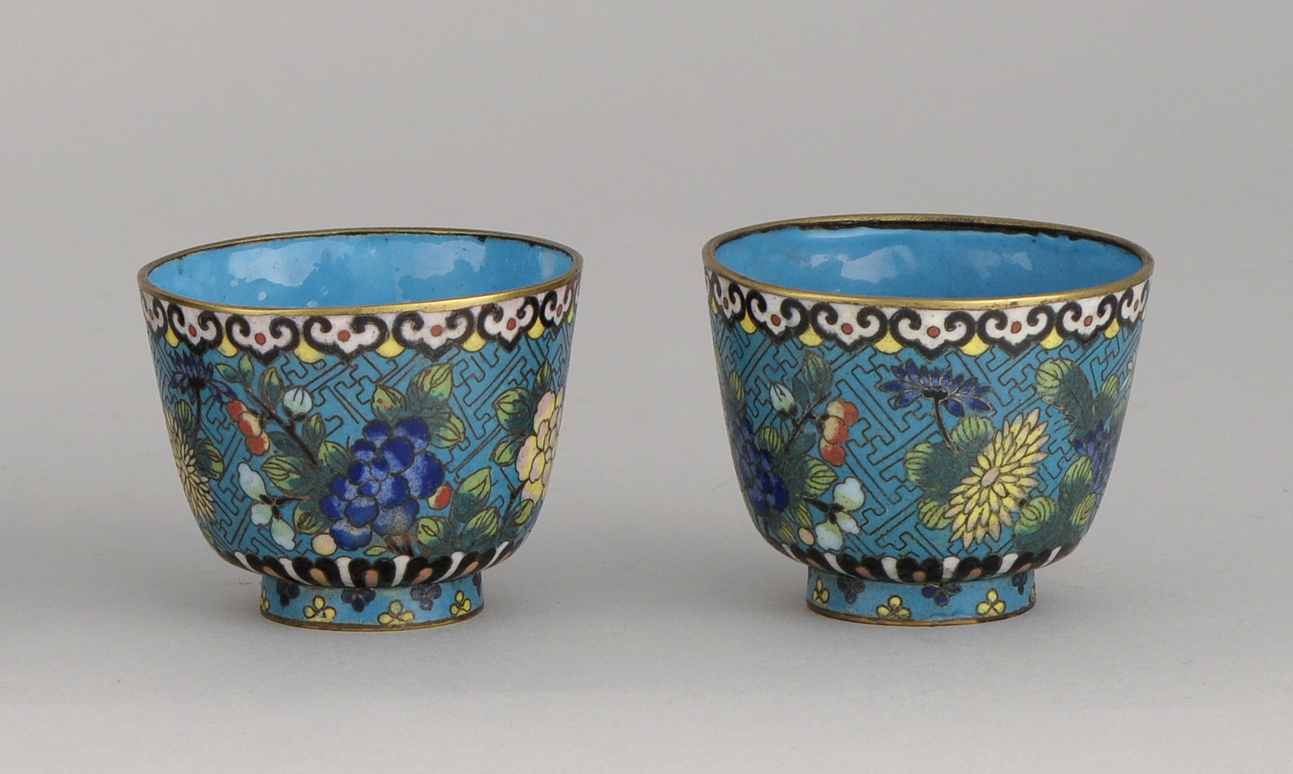 Appraisal: PAIR OF CLOISONN ENAMEL CUPS th CenturyWith floral design on