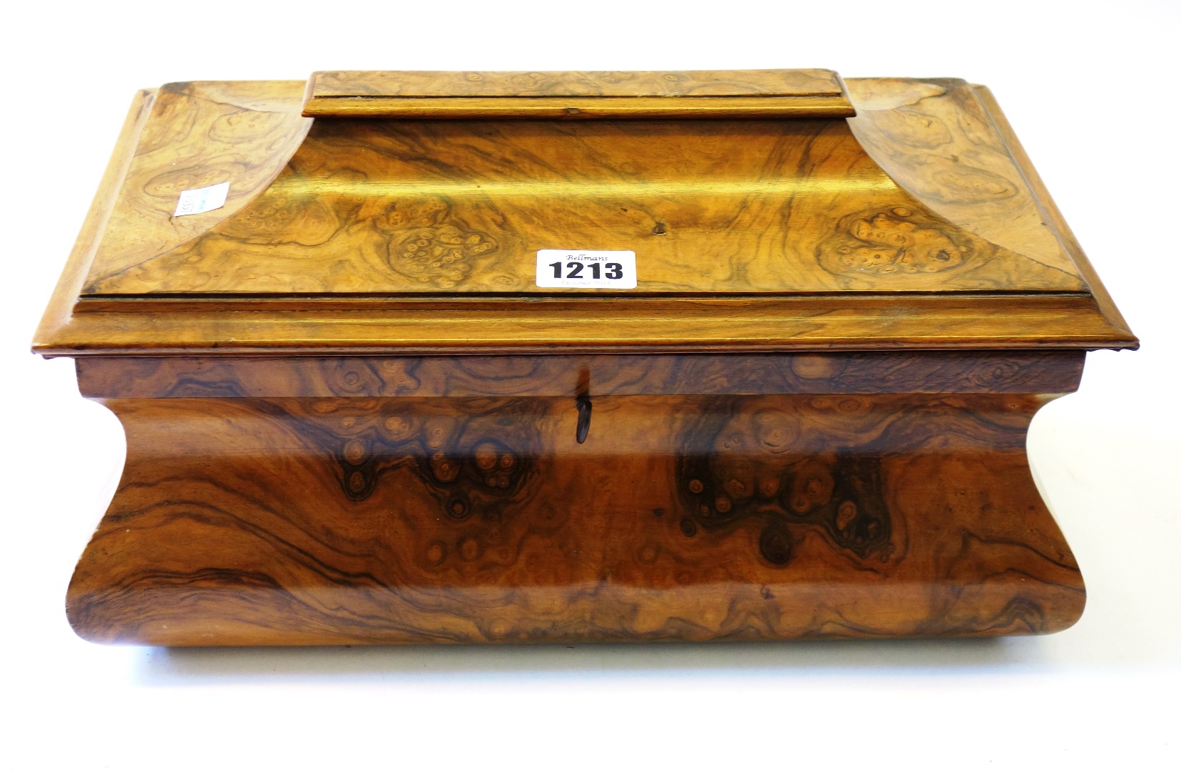 Appraisal: A Victorian figured walnut tea caddy of bloated sarcophagus form