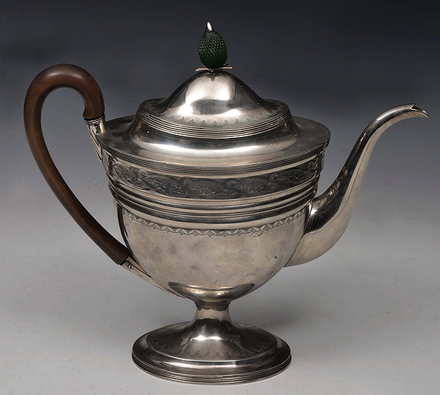 Appraisal: A GEORGE III SILVER TEAPOT of oval tapering form engraved