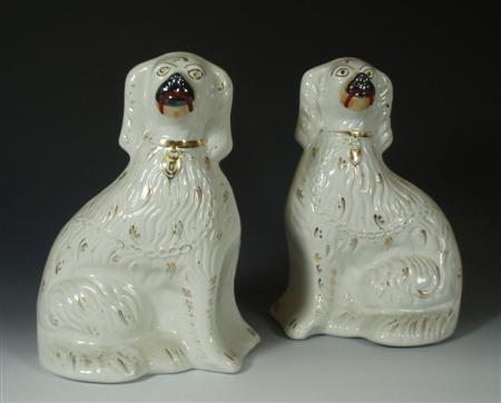 Appraisal: A pair of Victorian Staffordshire dogs sitting with gilt decoration