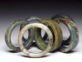 Appraisal: SIX JADE AND HARDSTONE BANGLES Six Chinese carved jade and