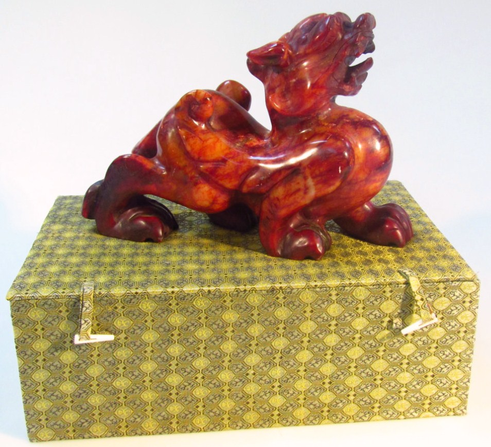 Appraisal: A thC Chinese polished soapstone style dog of fo heavily