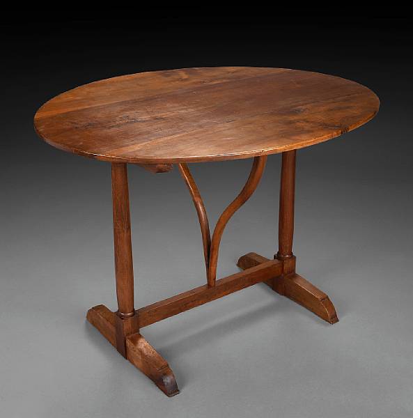 Appraisal: A French Provincial walnut tilt top occasional table th century