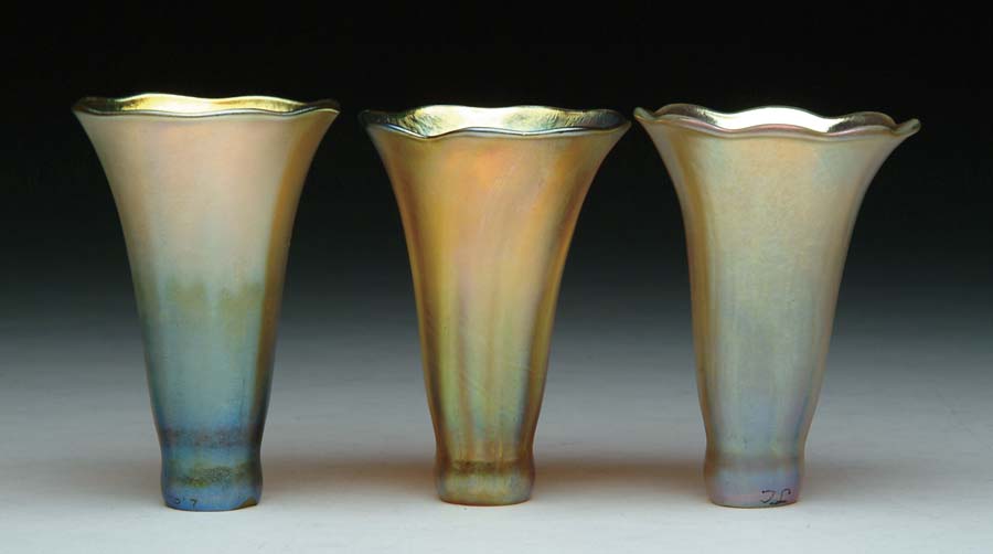 Appraisal: THREE TIFFANY ART GLASS SHADES Iridescent gold lily shades with