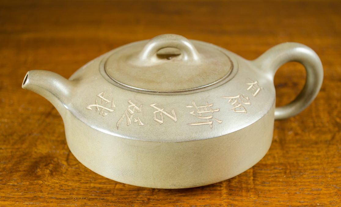 Appraisal: CHINESE ZISHA TEAPOT having incised script to top edge surrounding