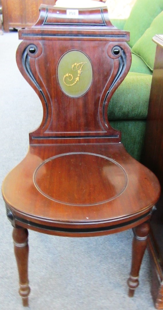 Appraisal: A pair of George IV mahogany hall chairs the cartouch