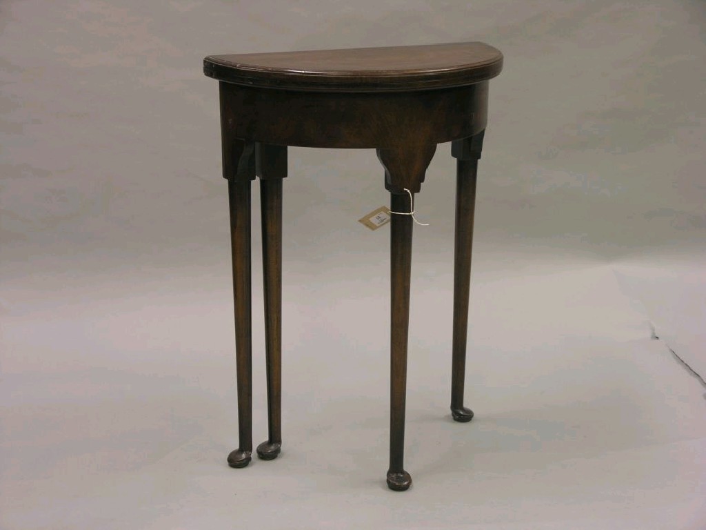 Appraisal: A reproduction demi-lune walnut hall table cross-banded hinged top enclosing