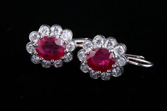 Appraisal: PAIR PLATINUM RUBY AND DIAMOND EARRINGS Floral motif mounts center