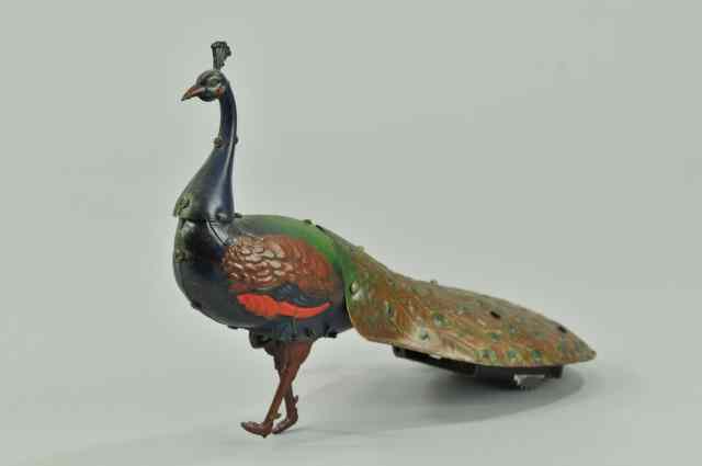 Appraisal: MECHANICAL WALKING PEACOCK Ebo Germany lithographed tin colorful peacock toy