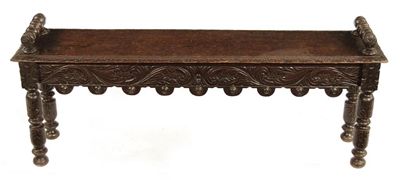 Appraisal: A carved oak hall bench with turned bolster lifts to