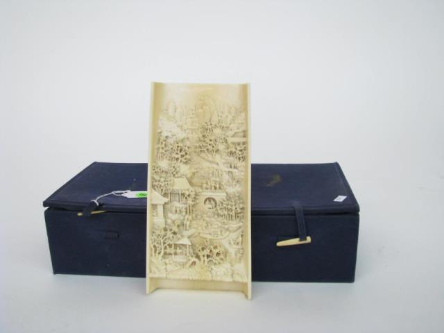 Appraisal: A Chinese ivory decorative carving depicting figures buildings and trees