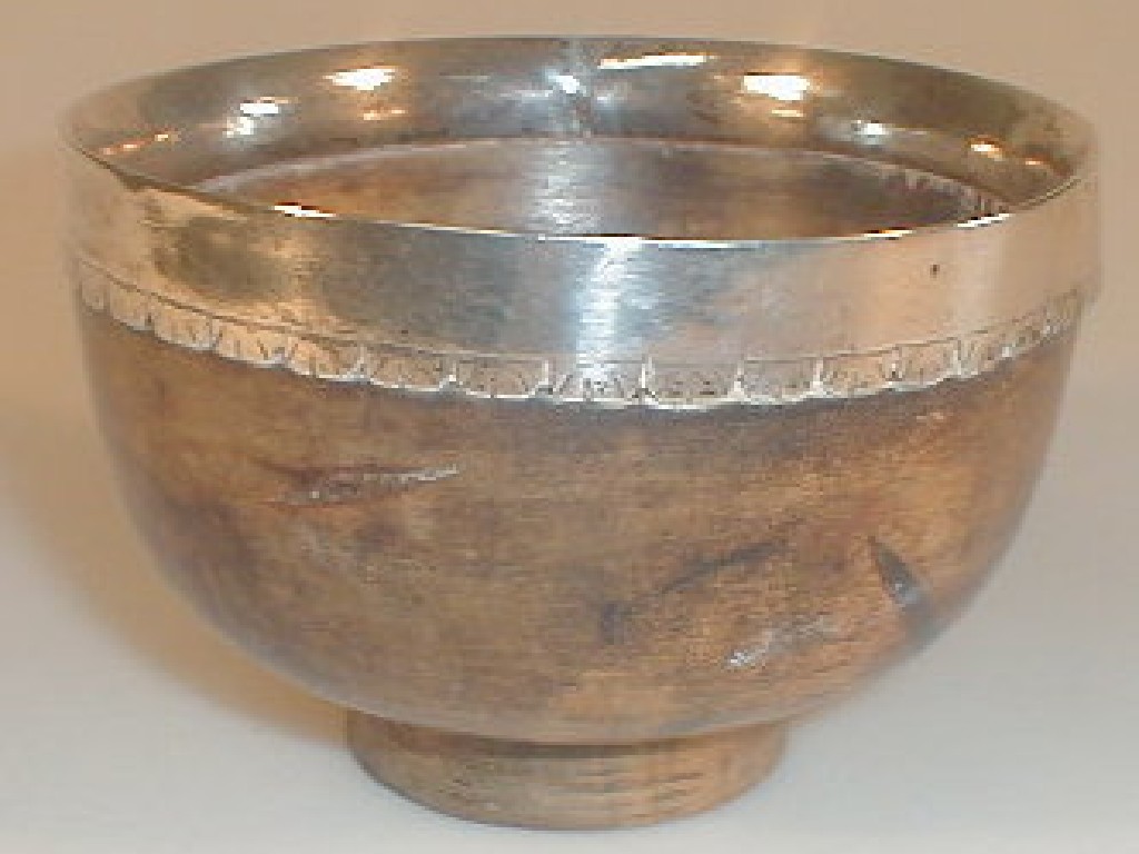 Appraisal: An thC polished coconut shell mazer bowl with a silver