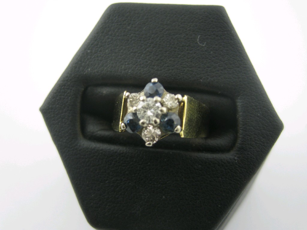 Appraisal: A Sapphire and Diamond Cluster Ring claw-set central brilliant-cut diamond