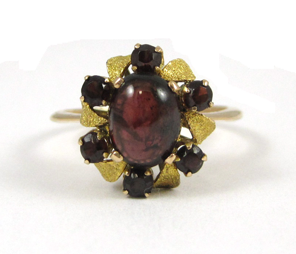 Appraisal: GARNET AND FOURTEEN KARAT GOLD RING with six round-cut garnets