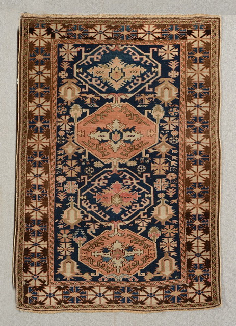 Appraisal: A CAUCASIAN BLUE GROUND MAT decorated four interlinked medallions within