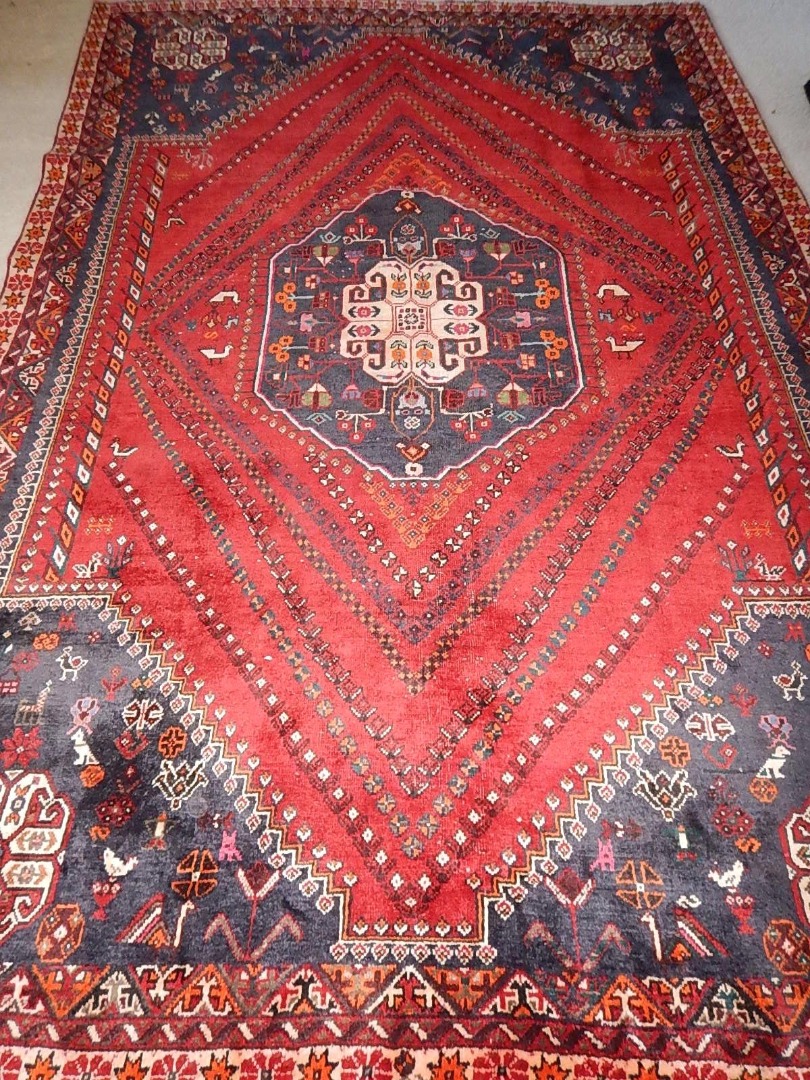 Appraisal: A Shiraz carpet with medallion to the centre in red