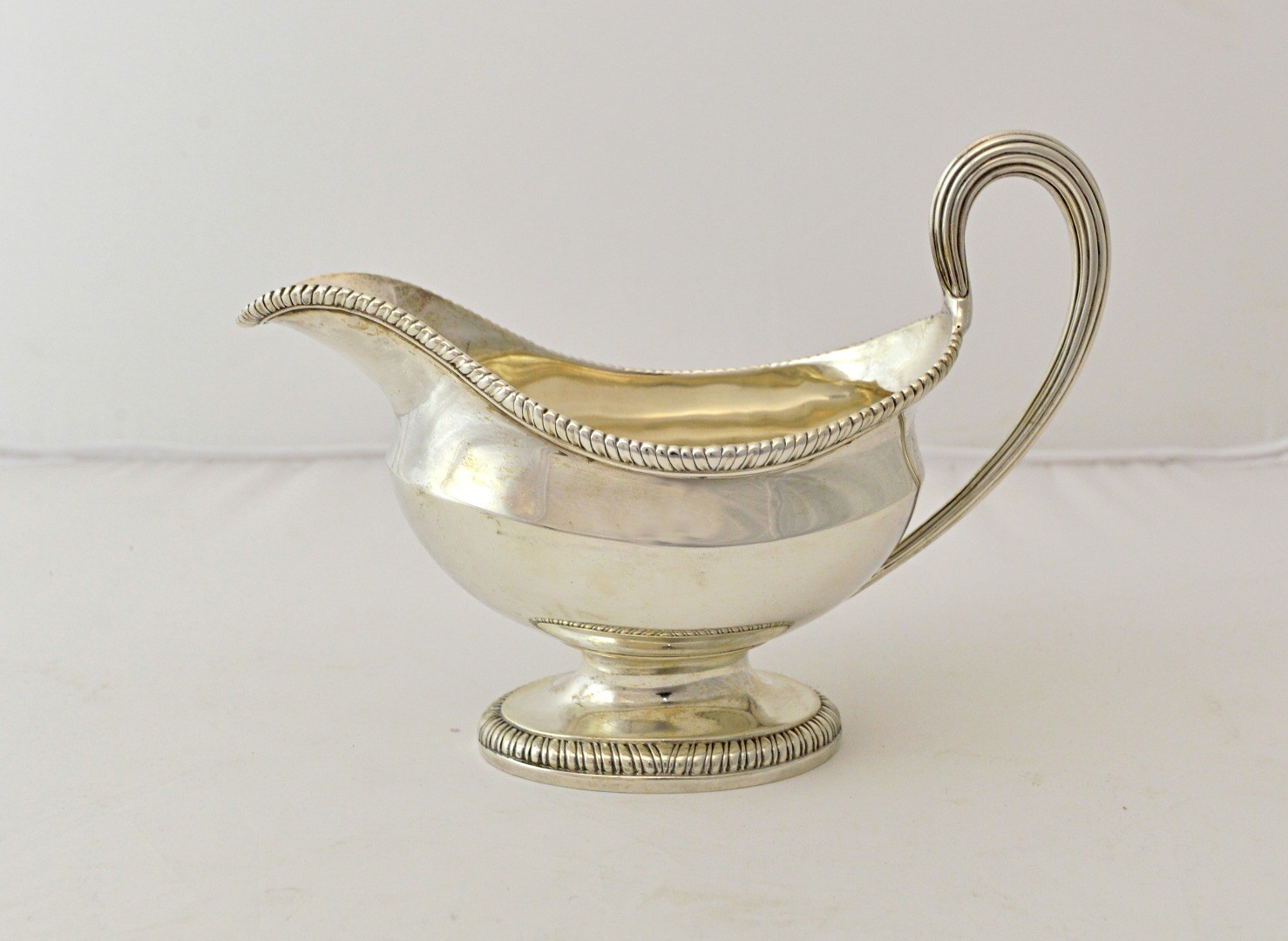 Appraisal: A George III silver sauceboat of oval form with a