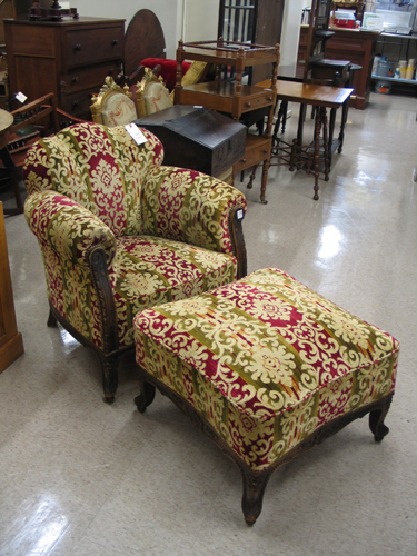 Appraisal: AN UPHOLSTERED AND CARVED OAK EASY CHAIR WITH MATCHING OTTOMAN