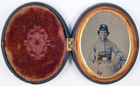 Appraisal: CONFEDERATE SOLDIER TINTYPE WITH SWORD Unidentified confederate soldier seated holding