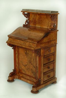 Appraisal: A MID VICTORIAN BURR WALNUT DAVENPORT the raised back with