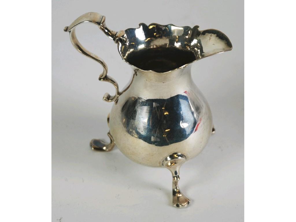 Appraisal: GEORGE II SILVER CREAM JUG baluster form with cyma border