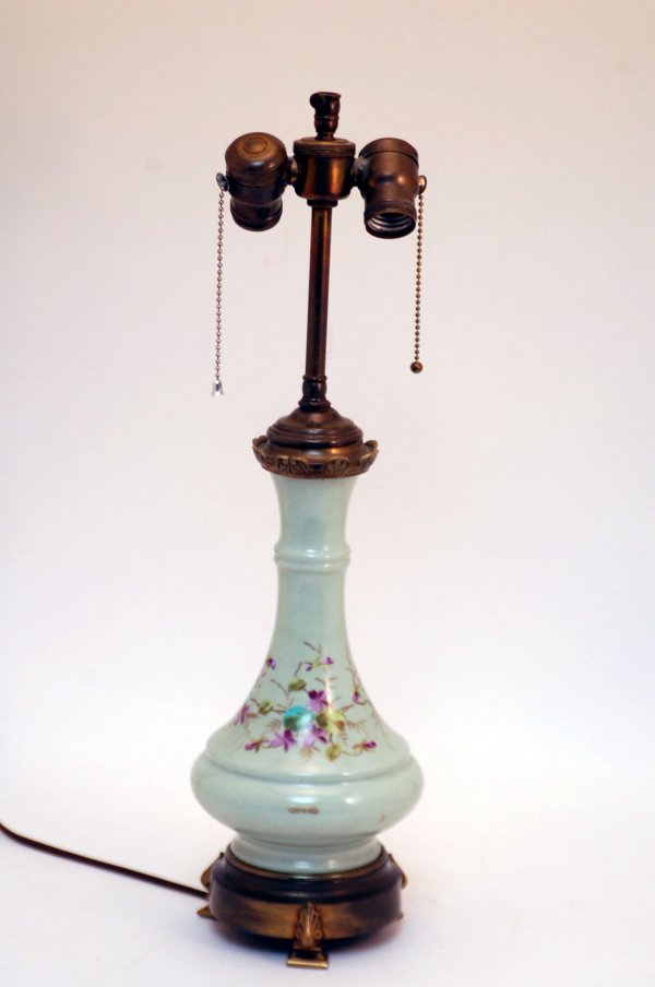 Appraisal: Green glass lamp atop a brass base with three feet