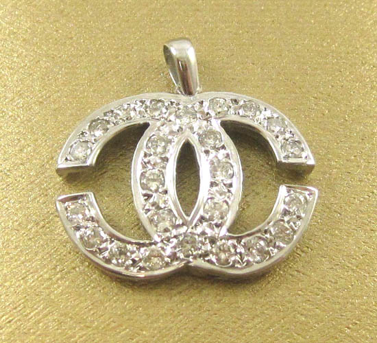 Appraisal: DIAMOND AND WHITE GOLD CHANEL LOGO PENDANT k white gold