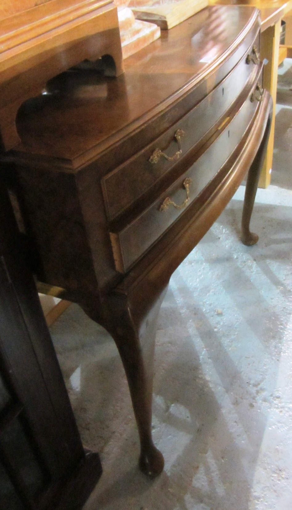 Appraisal: A walnut bowfront two drawer side table with quarter veneered