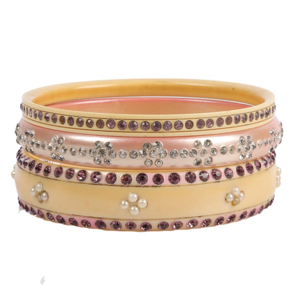 Appraisal: THREE PINK AND PURPLE ON PEARLIZED CREAM CELLULOID SPARKLER BANGLE