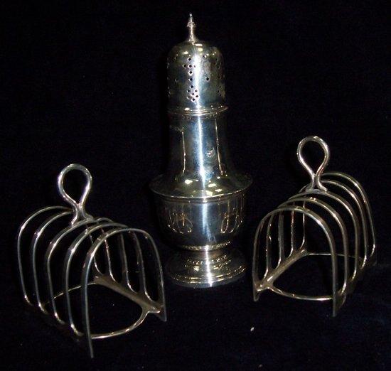 Appraisal: A pair of five-bar toast racks with ring handles Sheffield