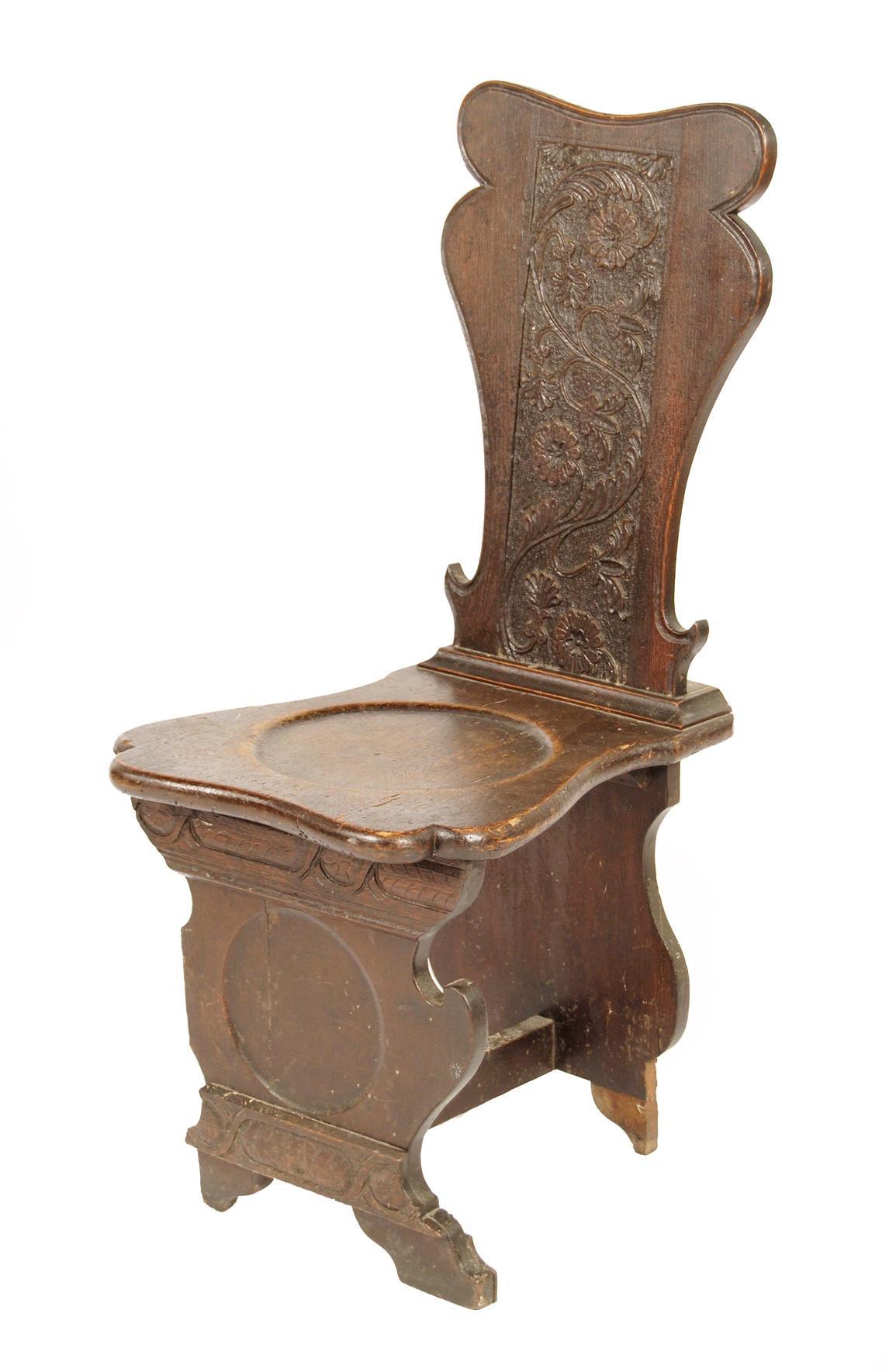 Appraisal: A carved oak hall chair of sgabello form