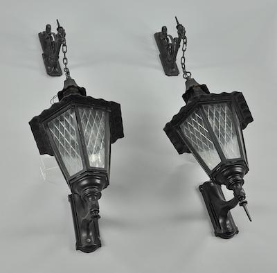 Appraisal: A Pair of Monumental Lanterns Patinated aluminum wall-mount hanging lanterns