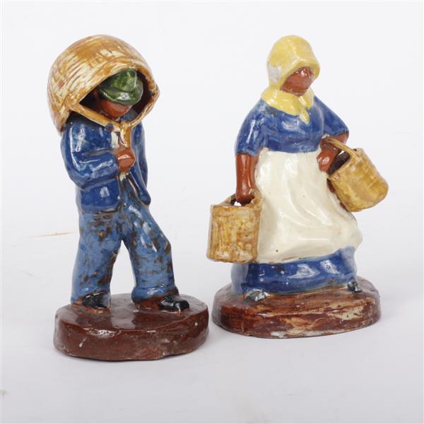 Appraisal: Pair of Brown County high glaze pottery figures carrying baskets