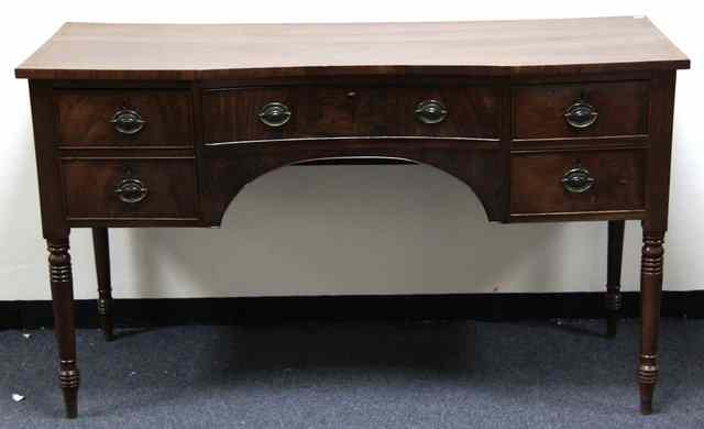 Appraisal: A Regency mahogany sideboard with indented front and drawer upon