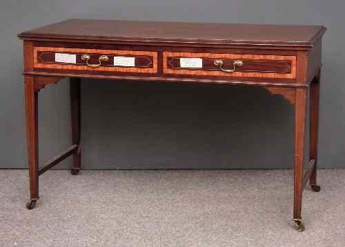 Appraisal: An Edwardian mahogany writing table inlaid with boxwood stringings fitted