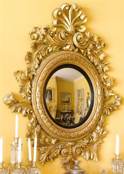 Appraisal: Large Neoclassical carved giltwood convex mirrorlate th century