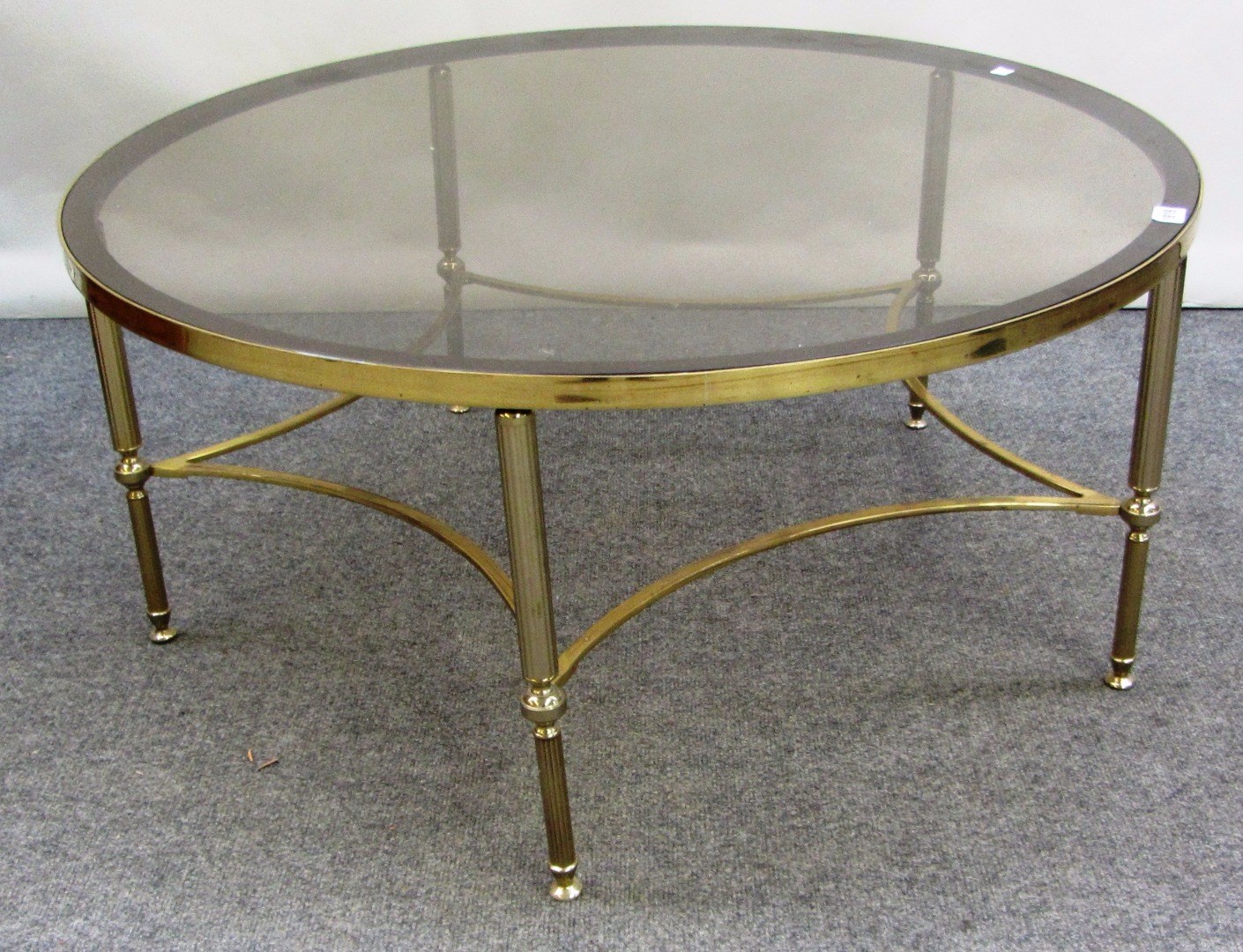 Appraisal: A th century lacquered brass and glass circular coffee table