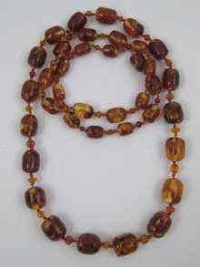 Appraisal: An amber bead necklace the largest bead approx cm long