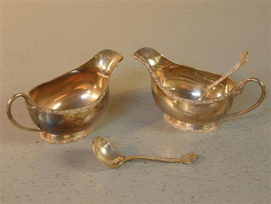 Appraisal: Pair of modern Lindisfarne style silver sauceboats with decorative rims