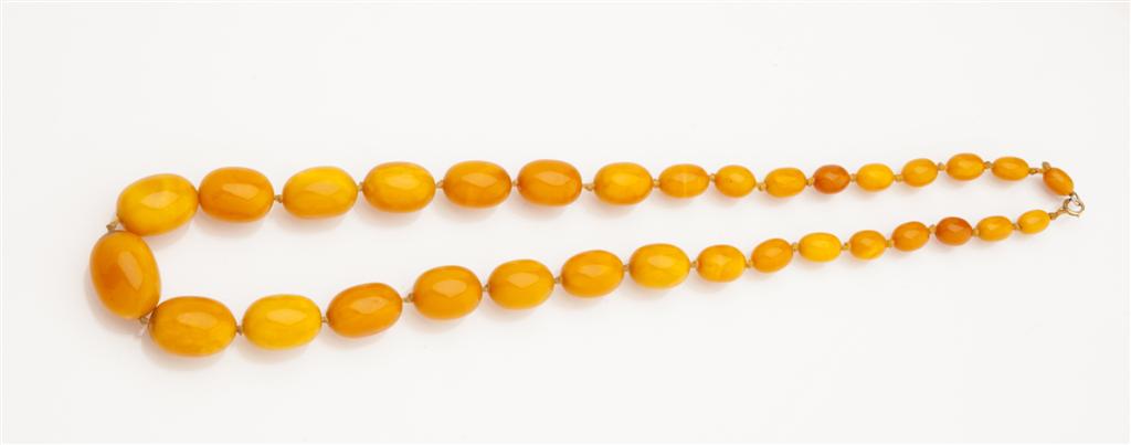 Appraisal: An amber necklace yellow orange graduated beads simple clasp Length