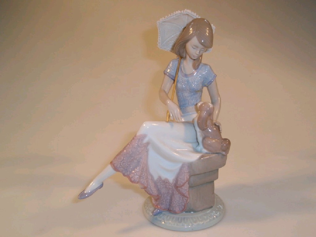 Appraisal: A Lladro porcelain figure of a young girl holding a