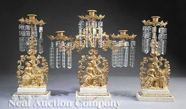 Appraisal: An American Rococo Gilt Brass Three-Piece Girandole Garniture c depicting