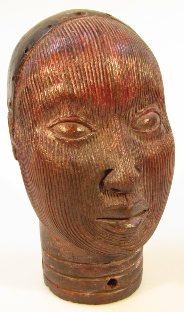 Appraisal: A Benin tribal terracotta head heavily carved to the front